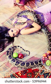 Shot of an oriental woman posing with a python.