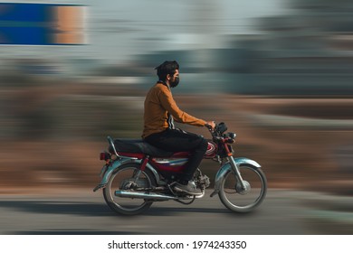 A Shot Of A Pakistani Boy Riding A Bike. Panning Photography. 