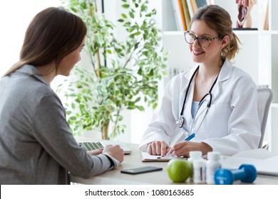 Shot Of Pretty Young Woman Talking With Dietician About Her Health In The Consultation.