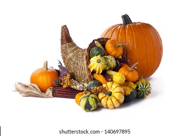 Shot Of A Pumpkin Beside A Wicker Cornucopia On White.