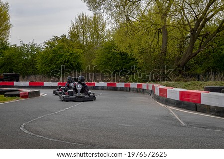 A shot of a racing kart as it circuits a track.