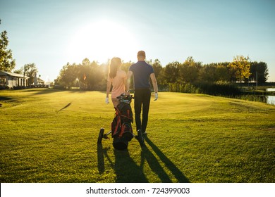 Shot Of A Retired Couple Standing On A Golf Green.