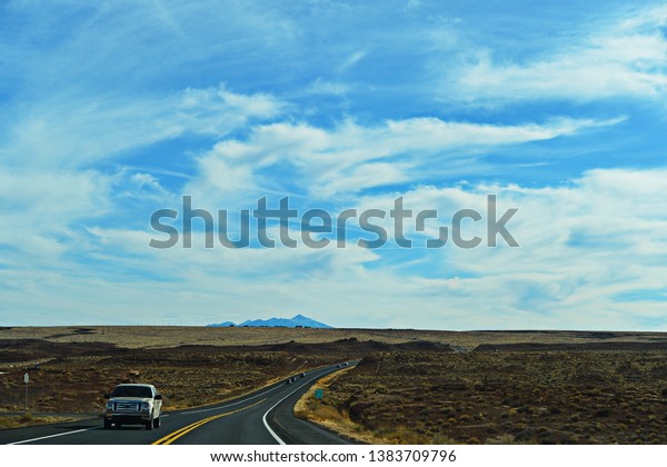 Shot of the road on Grand\
Canyon on a beautiful day, travelling by car in America, March 9th,\
2018