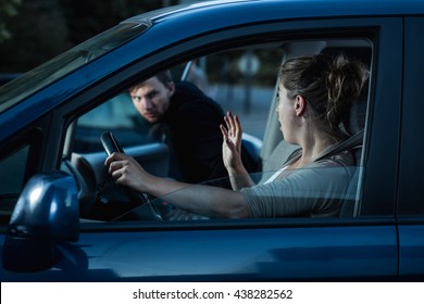 Shot Of A  Scared Woman Screaming While A Stranger Is Getting Into Her Car