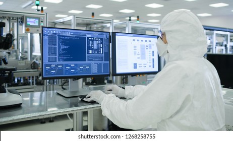 Shot of a Scientists in Sterile Suits Working with Computers, Analyzing Data form Modern Industrial Machinery in the Laboratory. Product Manufacturing Process: Pharmaceutics, Semiconductors - Powered by Shutterstock - Get 15% off with code: PIKWIZARD15