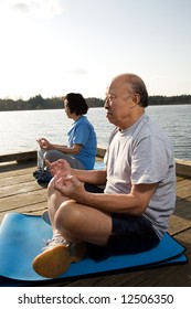 A Shot Of A Senior Asian Couple Meditating And Practicing Yoga