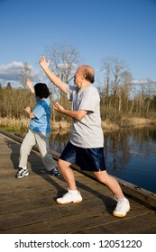 A Shot Of A Senior Asian Couple Practicing Taichi Exercise