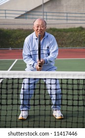 A Shot Of A Senior Asian Man Playing Tennis