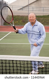 A Shot Of A Senior Asian Man Playing Tennis