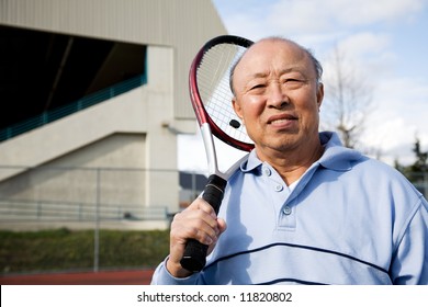 A Shot Of A Senior Asian Man Playing Tennis