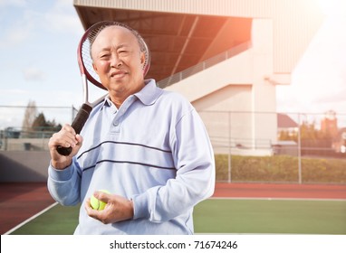 A Shot Of A Senior Asian Man Playing Tennis