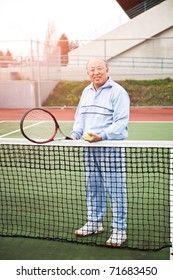 A Shot Of A Senior Asian Man Playing Tennis