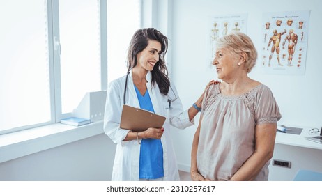 Shot of a senior woman having a consultation with her doctor. Senior woman having a doctors appointment. Doctor in blue uniform and protective face mask giving advice to Senior female patient