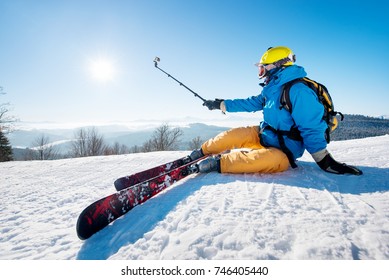 Shot Of A Skier Sitting On The Ski Slope Taking A Selfie Using Selfie Stick Resting Relaxing Extreme Recreation Active Lifestyle Activity Technology Smart Phone Mobility Internet Online Concept