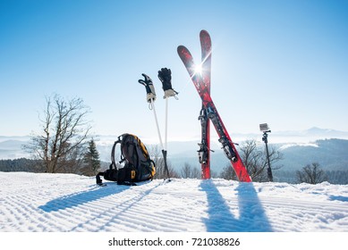 Shot Of Skiing Equipment - Skis, Backpack, Sticks, Gloves And Action Camera On Monopod, On Top Of The Ski Slope At Ski Resort In The Mountains Winter Sports Lifestyle Extreme Active Concept