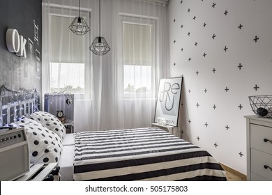 Shot Of A Small Cozy Bedroom With Black And White Decorations