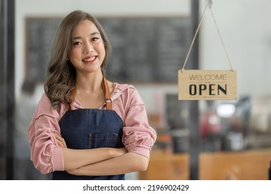 Shot Of Smiling Asian Young Sme Small Business Owner Wearing Apron And Standing White Ipad And Open Sign Coffee Shop Door, Asian Business Woman Barista Cafe Owner SME Entrepreneur Seller Concept