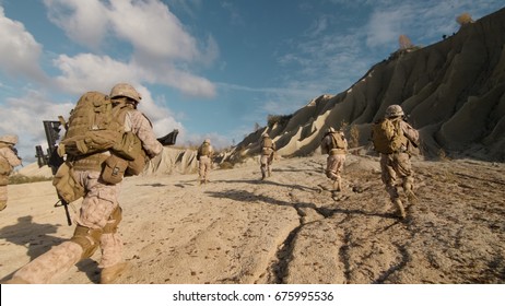 Shot of a Squad of Soldiers Running Forward and Atacking Enemy During Military Operation in the Desert.