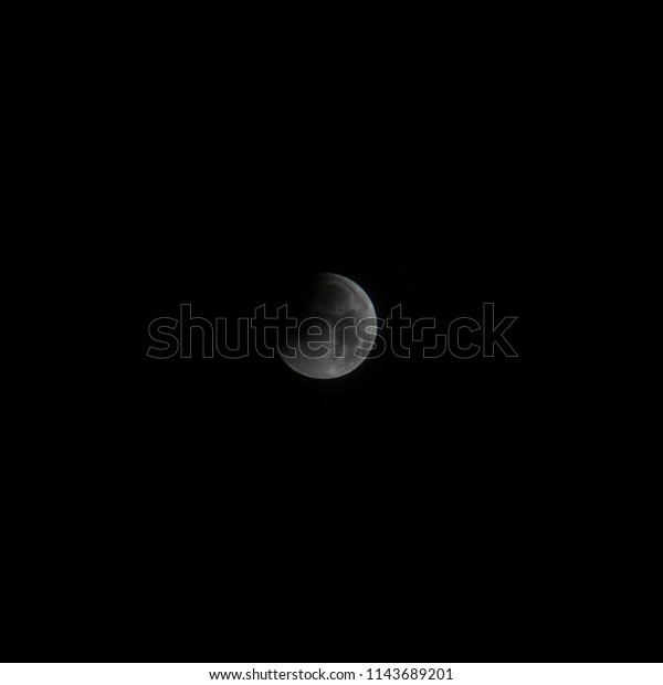A shot of a starting of the Lunar eclipse\
in Bangkok, Thailand on 28th July\
2018