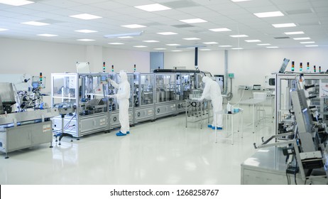 Shot Of Sterile High Precision Manufacturing Laboratory Where Scientists In Protective Coverall's Use Computers And Microscopes, Doing Pharmaceutics, Biotechnology And Semiconductor Research.