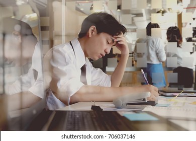  Shot Of Stressed Asian Business Man In The Office.