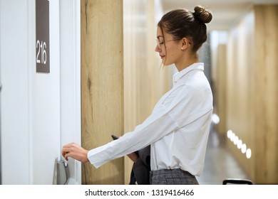 Shot Of Stylish Beautiful Businesswoman Opening The Door Of Her Hotel Room With Key Card In The Corridor Of The Hotel.