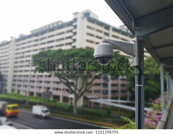 Shot of a surveillance camera is\
installed on a bridge to observe the surrounding\
area