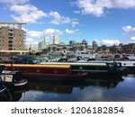 Shot taken at Limehouse Marina (London) - a calm scene of canalboats parked at the Marnia, away from the bustle of Canary Wharf, seen in the distance. 