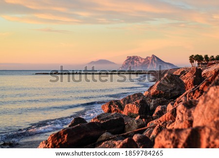 A shot taken at sunrise from Spain. Showing the Spanish shoreline, then Gibraltar with Africa in the distance.