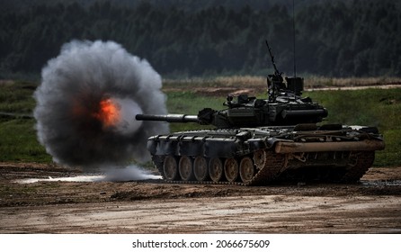 Shot from a tank gun with a smoke ring, the frame of military operations. Russian Modern tank Shooting at a target. Smoke, explosion, military Exercises, Military operations