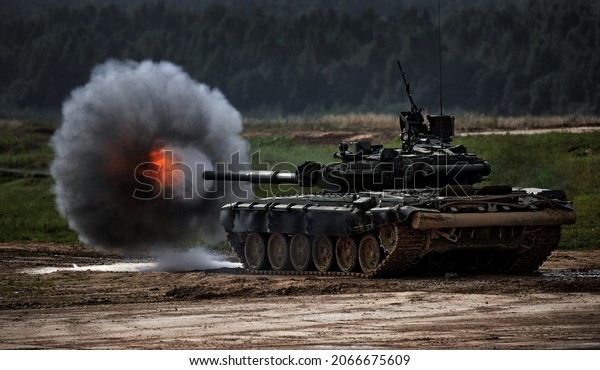 Shot\
from a tank gun with a smoke ring, the frame of military\
operations. Russian Modern tank Shooting at a target. Smoke,\
explosion, military Exercises, Military\
operations