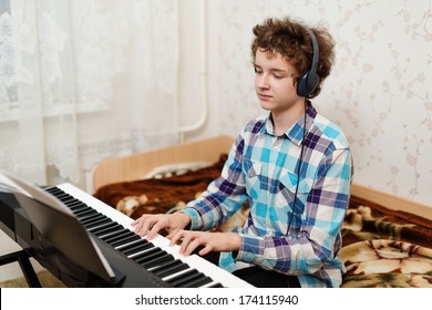 A Shot Of Teenager Boy Playing Piano 