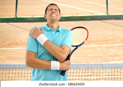 Shot Of A Tennis Player With A Shoulder Injury On A Clay Court