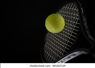 A shot of a tennis racket hitting a tennis ball.