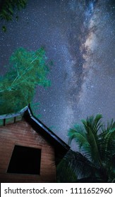 Shot This Milky Way Galaxy In Asia. It Is Really Beautiful. Big Tree Log, And House Are Use As Foreground. The Galaxy Is The Background. It Shows The Connection Between Universe And The Earth.