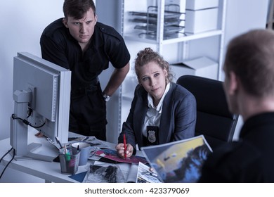 Shot Of Three Young Police Officers Talking 