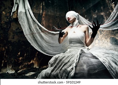 Shot of a twilight girl in white dress. Halloween, horror.