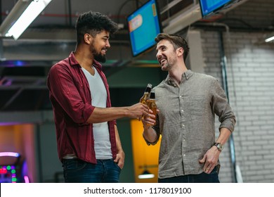 Shot Of Two Man Cheering With Beer