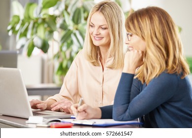 Shot of two professional women working together on a new business project. - Shutterstock ID 572661547