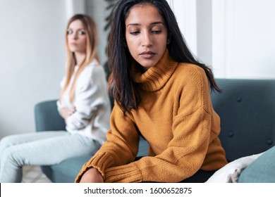 Shot of two upset friends not talking to each other after fight on the sofa at home. - Powered by Shutterstock