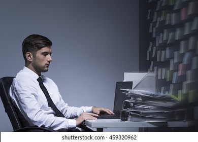 Shot Of An Unhappy Employee Sitting In An Office And Working With His Laptop