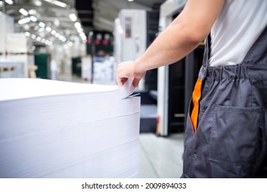 Shot Of An Unrecognizable Print Worker Ready To Place Blank Sheets Of Paper Into Offset Machine For Printing.