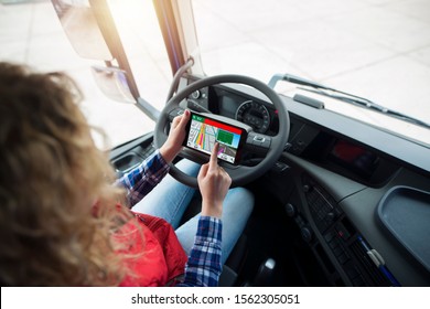 Shot Of An Unrecognizable Truck Driver Using Global Positioning System GPS Navigation For Destination. Fingers Choosing Route Navigation. Transportation Services.