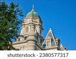 Shot of upper roof top view with blue sky behind it and clock tower on Whitley County Courthouse