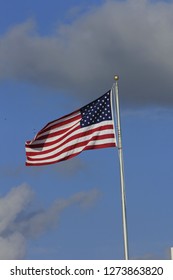 A shot of a USA Flag on a metal flag pole with blue sky and clouds. Thats shot vertical. In Hutchinson Kansas USA. - Shutterstock ID 1273863820