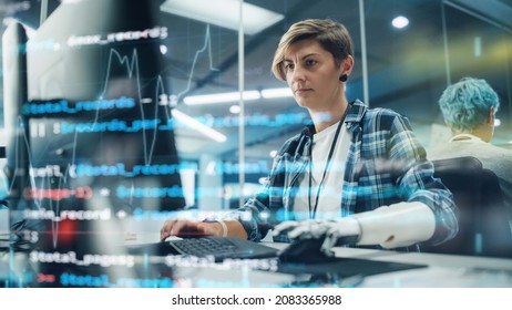 Shot With Visualisation Of Running Computer Code On Foreground. Portrait Of Motivated Woman With Disability Using Prosthetic Arm To Work On Computer In Body Positive Office. Myoelectric Bionic Hand