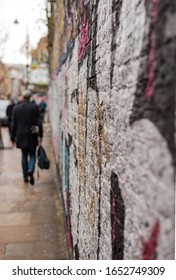 A shot of a wall with graffiti looking down a street in Shoreditch in East London