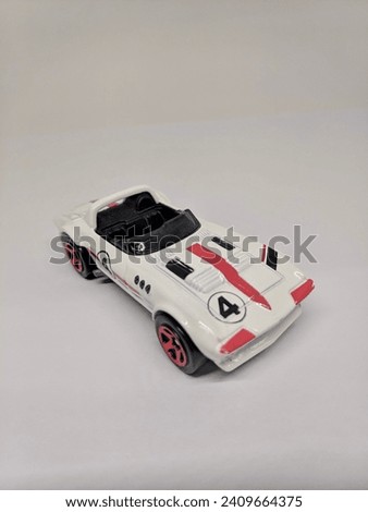 A shot of white toy model car (diecast) against white background. Jakarta - Indonesia.
