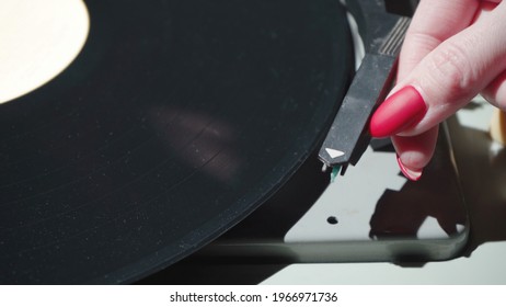 Shot of woman with red nails and retro gramophone - Shutterstock ID 1966971736
