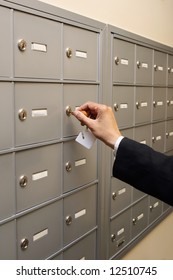 A Shot Of A Woman Unlocking A PO Box.